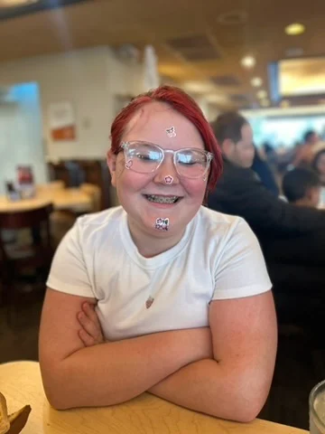 Ava smiling with playful face stickers