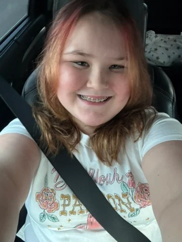 Ava smiling in the car